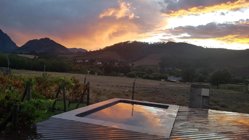 a view of a sunset from the roof of a house at Cottage K'Gari in Franschhoek