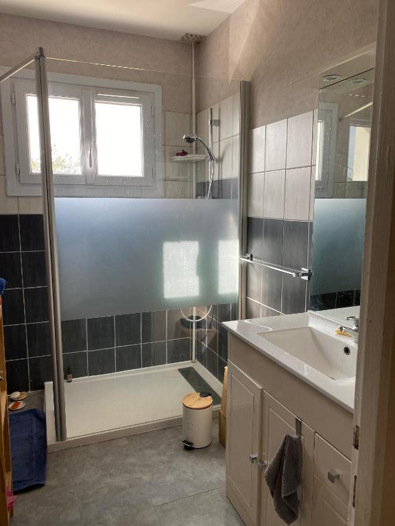 a bathroom with a shower and a sink and a tub at Maison de Ophelia in Périgné