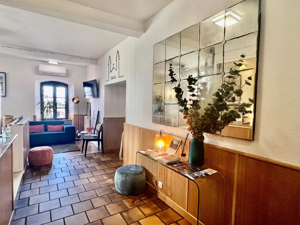 a living room with a couch and a table at Hôtel Posta Vecchia in Bastia