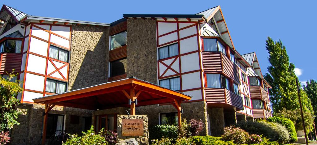 a large building with a sign in front of it at Calafate Parque Hotel in El Calafate