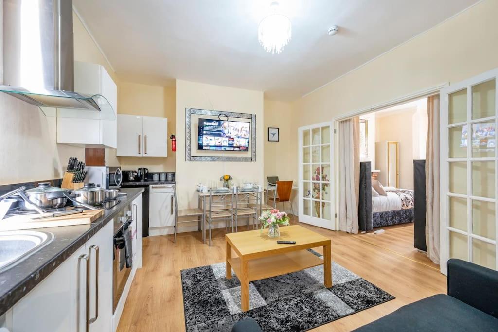 a kitchen and living room with a table at *1va* ground floor apartment setup for your most amazing & relaxed stay + Free Parking + Free Fast WiFi * in Killingbeck