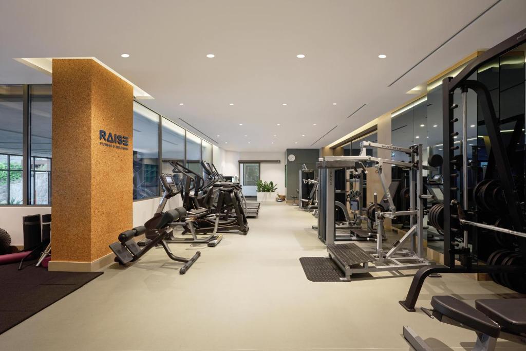 a gym with treadmills and machines in a building at METT Hotel & Beach Resort Bodrum in Bodrum City