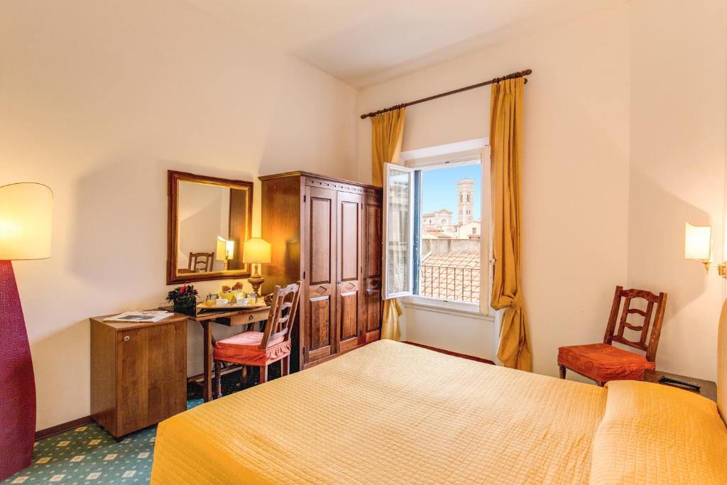 A bed or beds in a room at Hotel S.Giorgio & Olimpic
