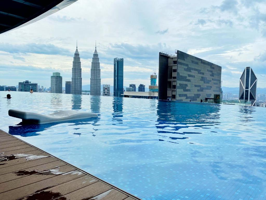 a swimming pool on the roof of a building at Amazing KLCC SKY view infinity pool Eaton Residences Suites in Kuala Lumpur