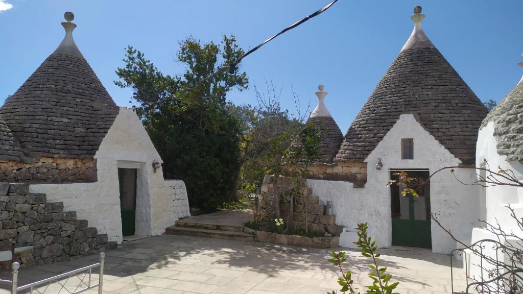 a group of buildings with turrets at Trulli di Ivana in Ostuni