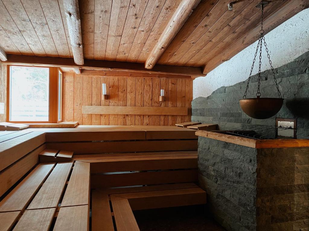 a sauna with a bench in a room at Spa Hotel Zedern Klang in Hopfgarten in Defereggen