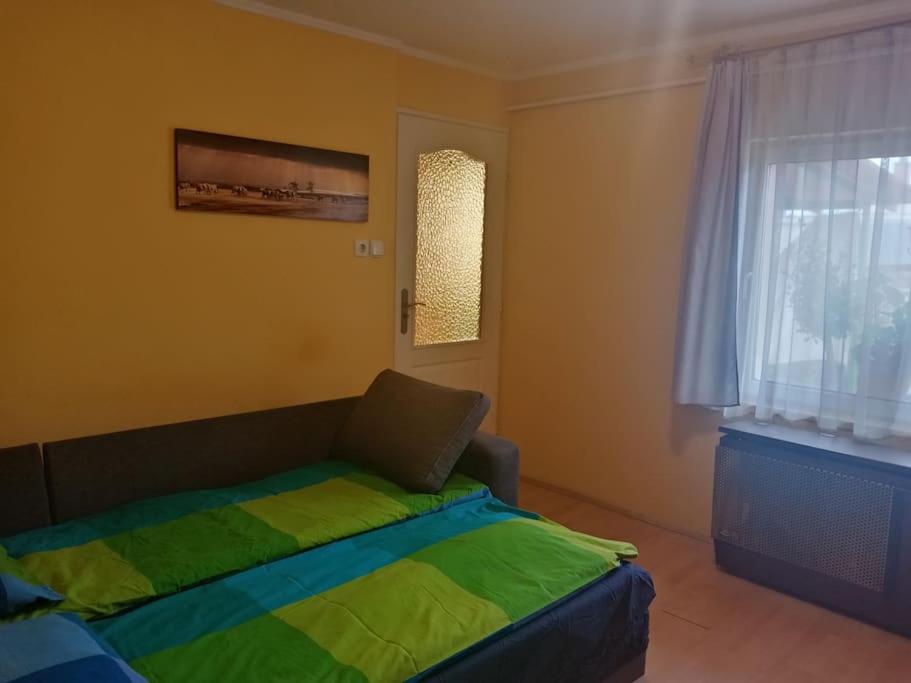 a bedroom with a bed and a window at D38 Pestelizabeth Apartman in Budapest