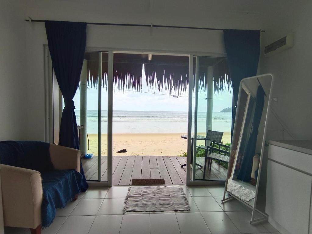 a living room with a view of the beach at Tiongman Scubadive & Lodge in Tioman Island