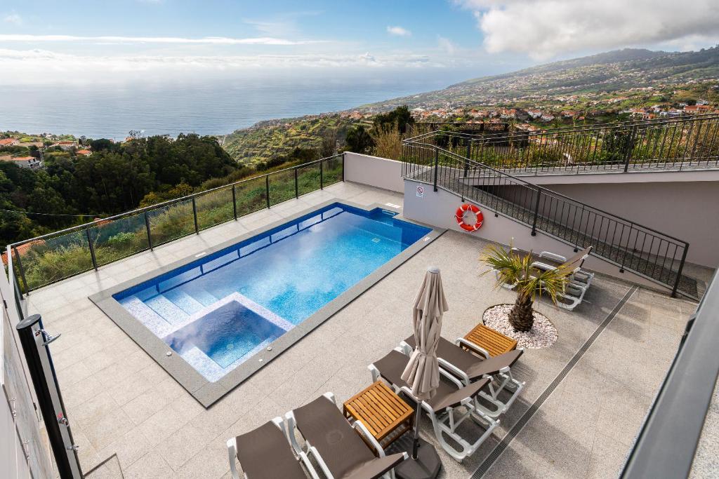 a swimming pool on the balcony of a house at Casa Bella Vista - Calheta in Arco da Calheta