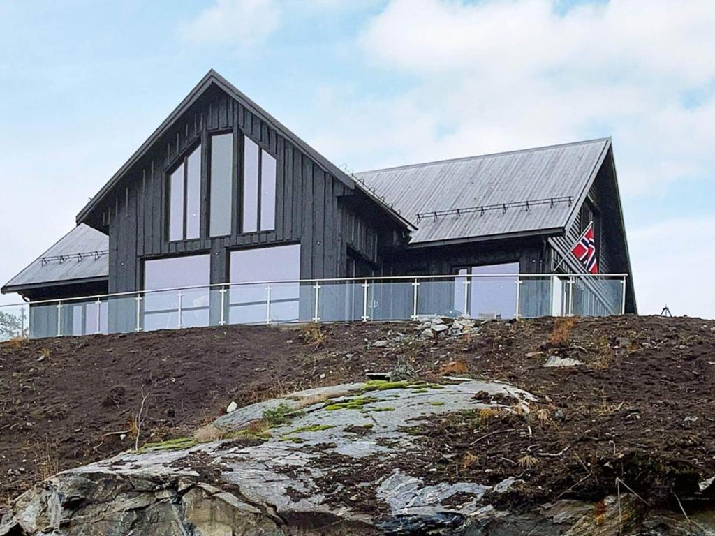 a black house on top of a hill at Holiday home Drangedal in Drangedal