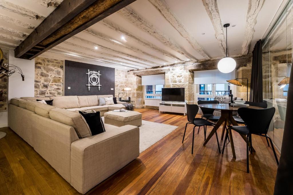 a living room with a couch and a table at AMELIA by SWEET HOME SAN SEBASTIAN in Donostia-San Sebastián