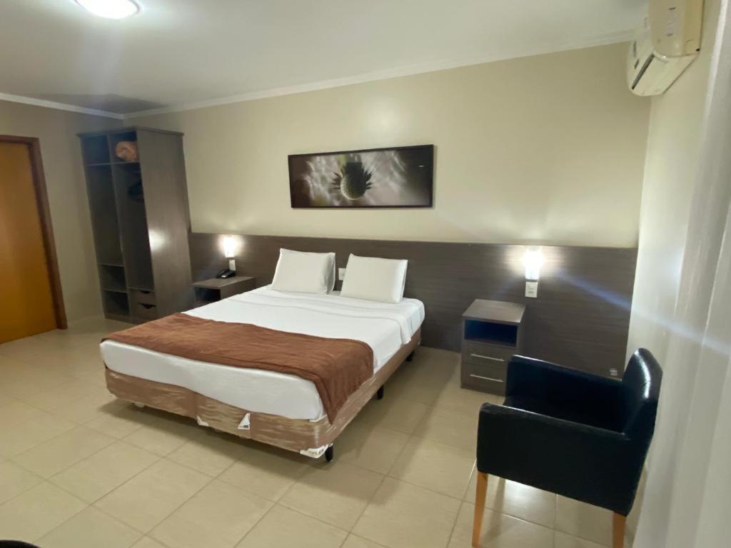 Postel nebo postele na pokoji v ubytování Class Hotel Passos Rio Grande Portal da Canastra