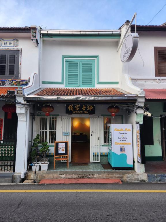 a building with a sign in front of it at Heeren Inn Melaka in Melaka