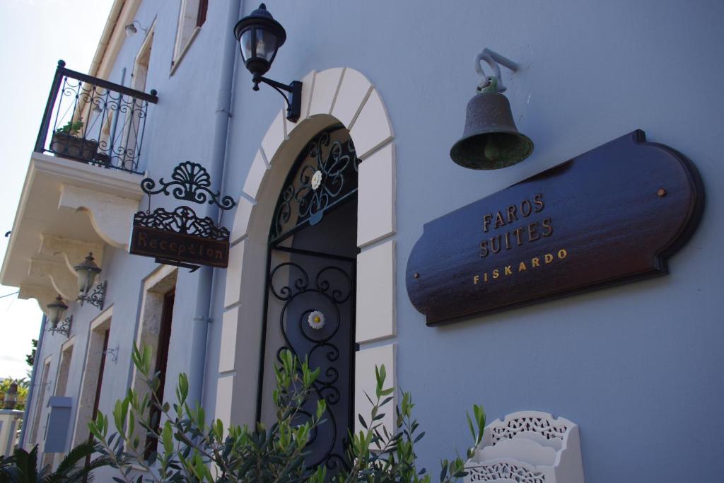 a sign on the side of a building with a street light at Faros Suites (Adults Only) in Fiskardho