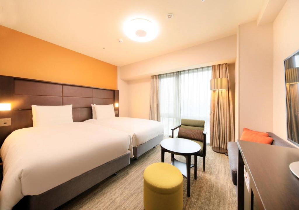 Postel nebo postele na pokoji v ubytování Richmond Hotel Namba Daikokucho