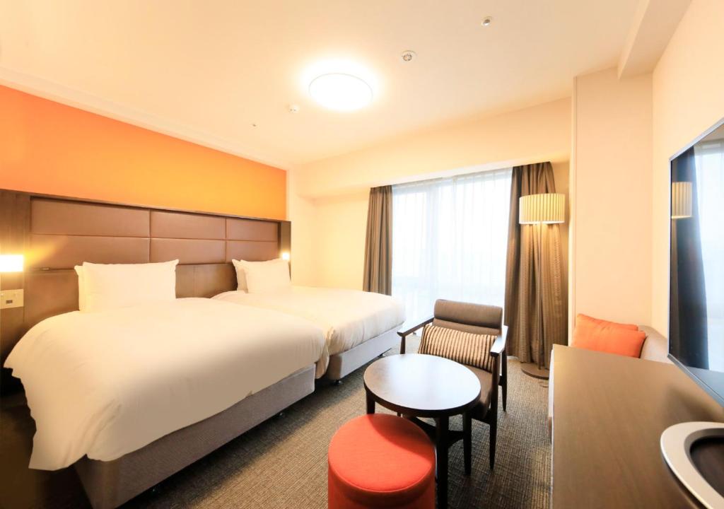 Postel nebo postele na pokoji v ubytování Richmond Hotel Namba Daikokucho