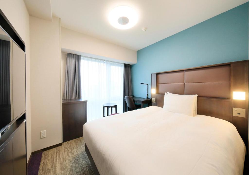 Postel nebo postele na pokoji v ubytování Richmond Hotel Namba Daikokucho