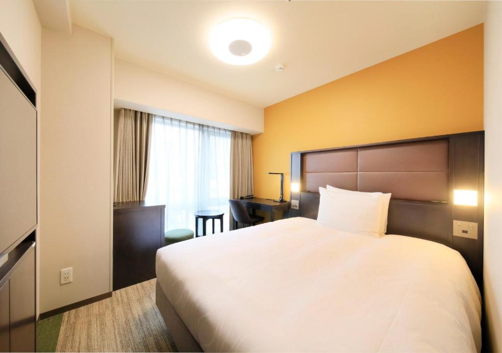 Postel nebo postele na pokoji v ubytování Richmond Hotel Namba Daikokucho