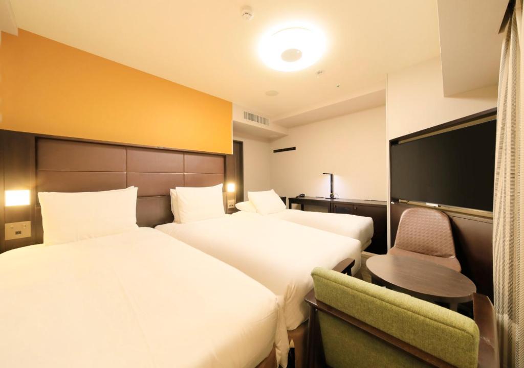Postel nebo postele na pokoji v ubytování Richmond Hotel Namba Daikokucho