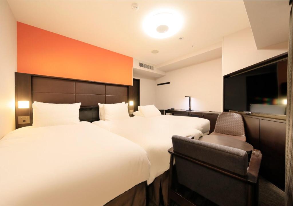 Postel nebo postele na pokoji v ubytování Richmond Hotel Namba Daikokucho
