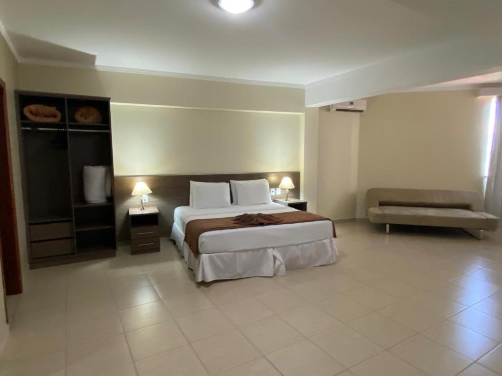 Postel nebo postele na pokoji v ubytování Class Hotel Passos Rio Grande Portal da Canastra