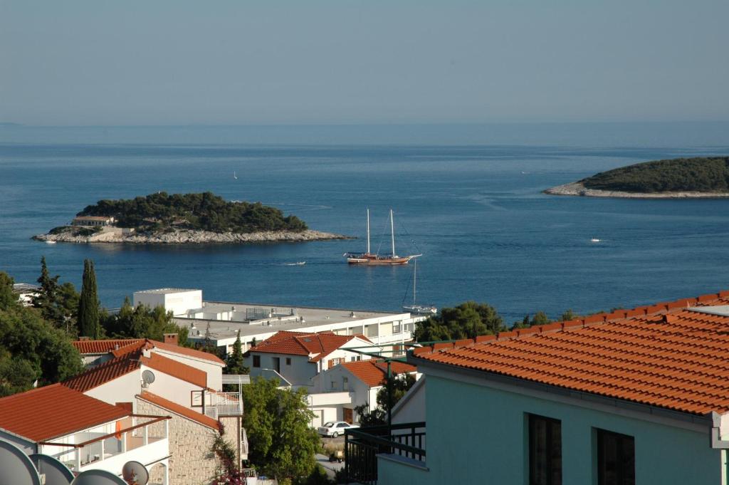 a view of a town with a boat in the water at Babo Apartments in Hvar