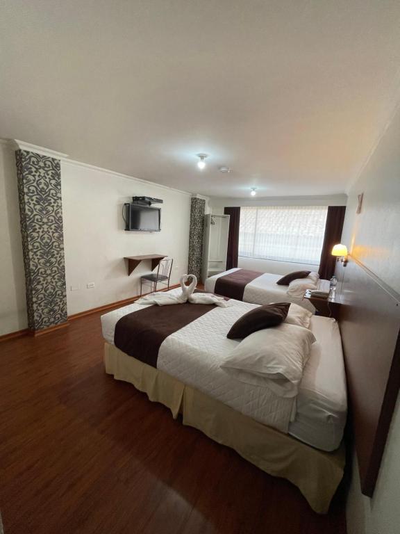 Postel nebo postele na pokoji v ubytování Gran Hotel Napoleón