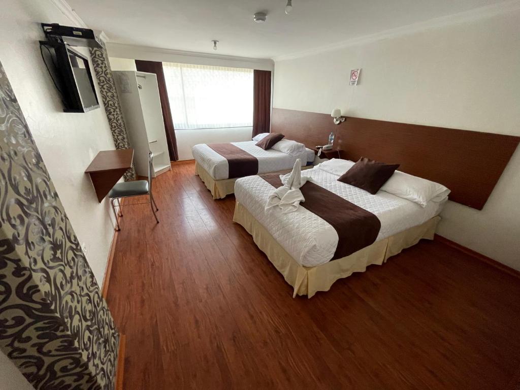 Postel nebo postele na pokoji v ubytování Gran Hotel Napoleón