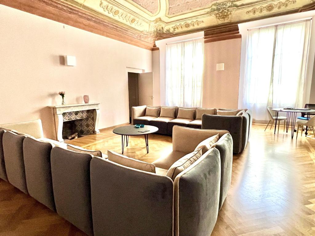 a large living room with couches and a fireplace at The Seven Suites in Genova