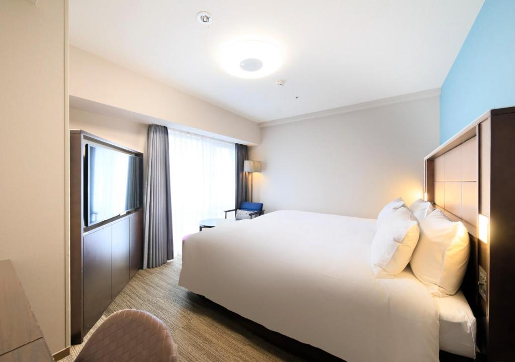 Postel nebo postele na pokoji v ubytování Richmond Hotel Namba Daikokucho