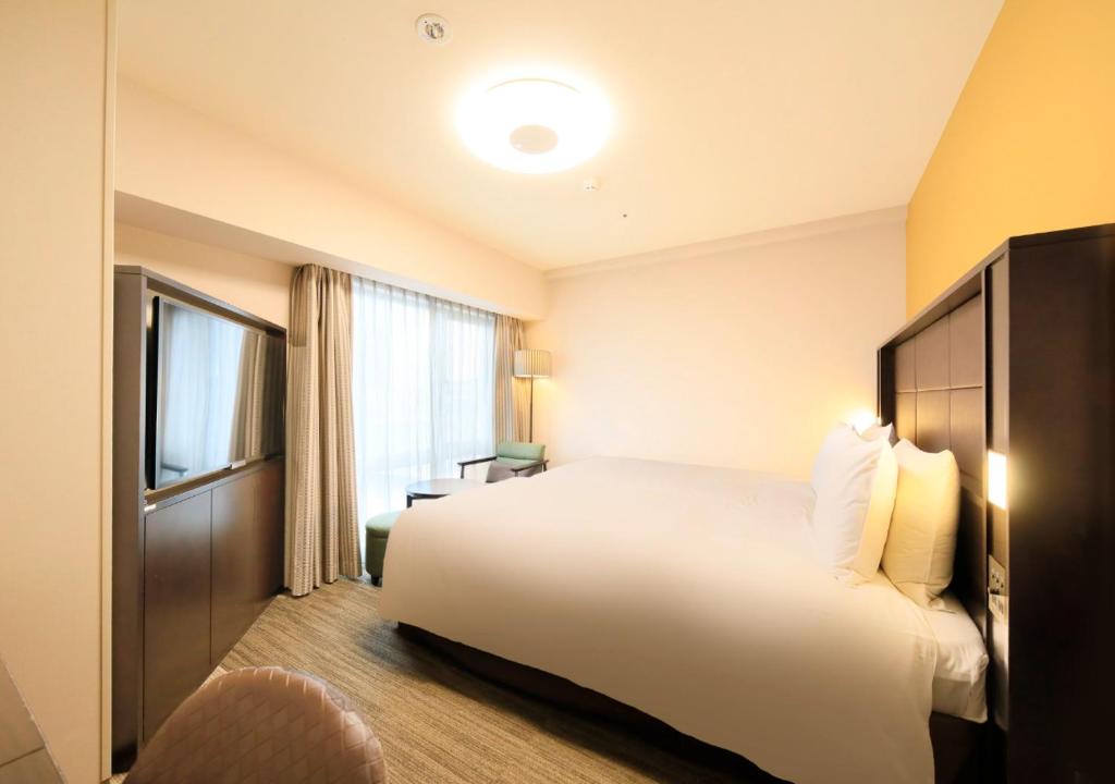 Postel nebo postele na pokoji v ubytování Richmond Hotel Namba Daikokucho