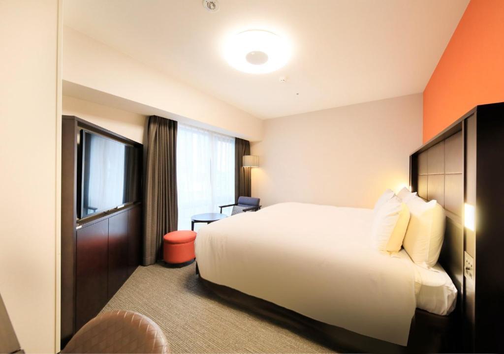 Postel nebo postele na pokoji v ubytování Richmond Hotel Namba Daikokucho