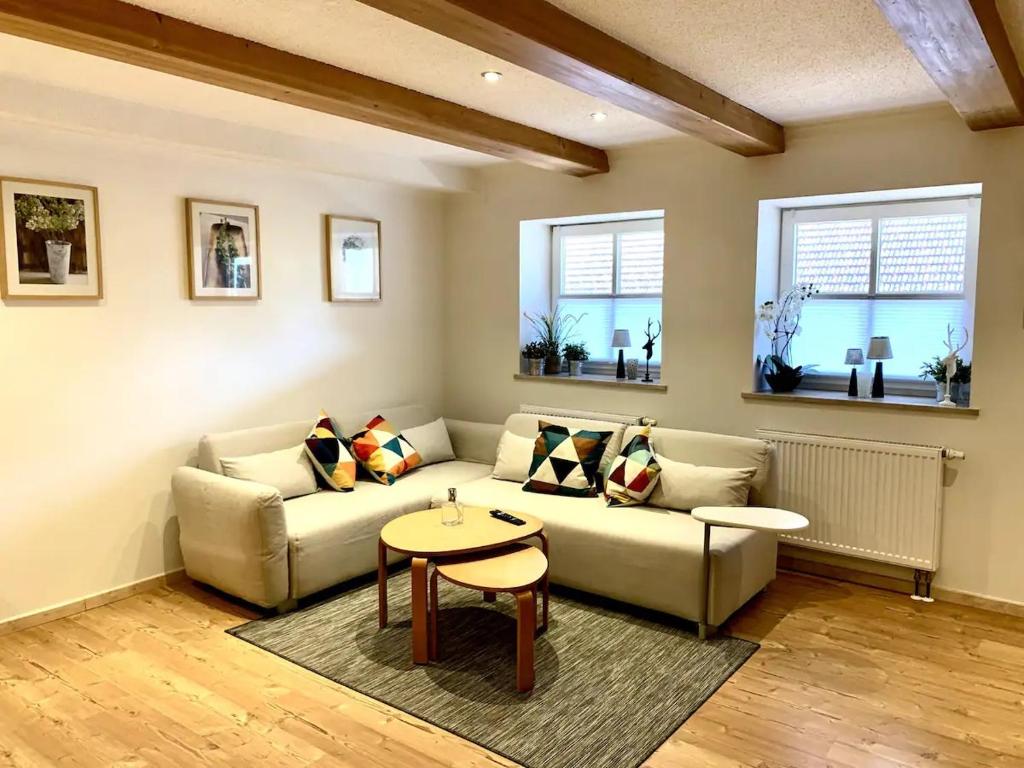 sala de estar con sofá y mesa en Ferienwohnung Vierseithof, en Eging