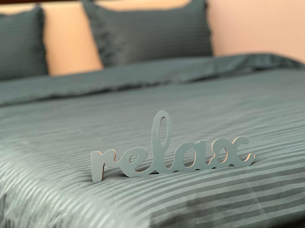 a close up of a bed with the word relax on it at English Breakfast in Chişinău