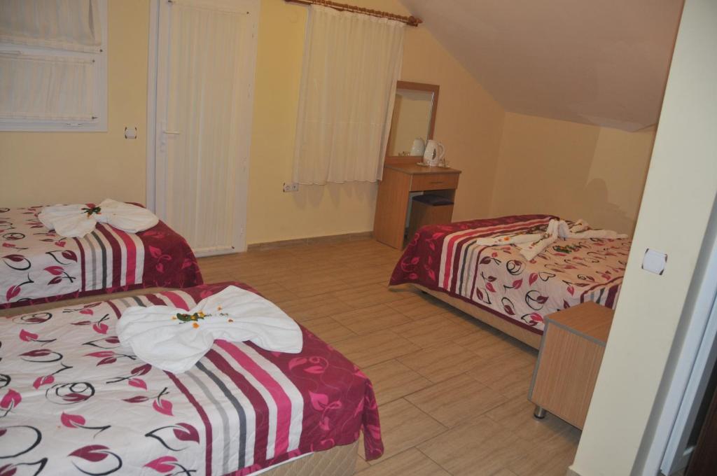 Postel nebo postele na pokoji v ubytování Tolay Hotel