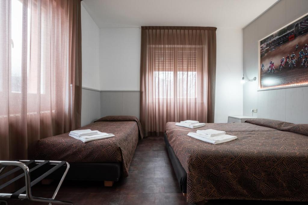 Postel nebo postele na pokoji v ubytování Hotel Ciclamino