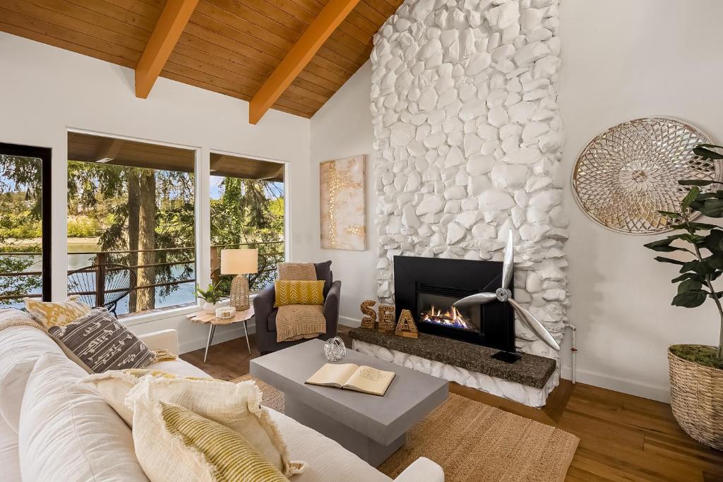 a living room with a white couch and a fireplace at Agate Bridge Beauty in Agate Point