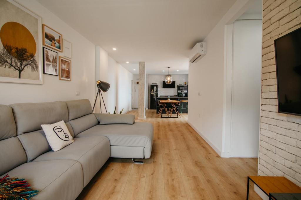 a living room with a couch and a television in it at tuGuest Carretera de la Sierra Apartment in Granada