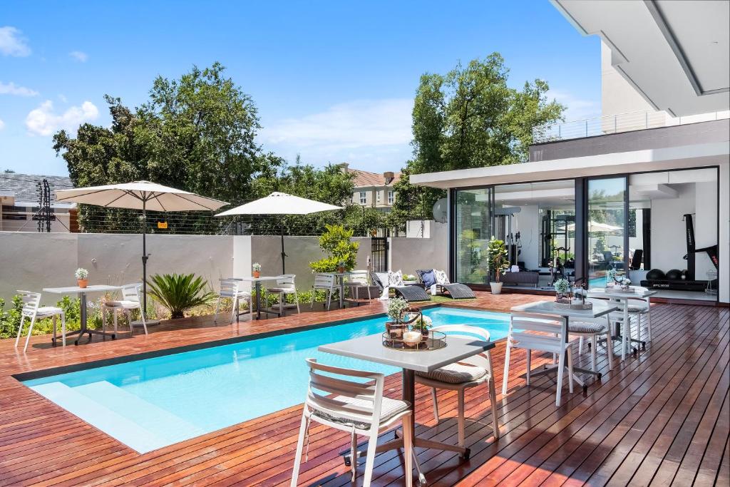 an image of a house with a swimming pool at One Hyde Park Apartments Sandton in Johannesburg