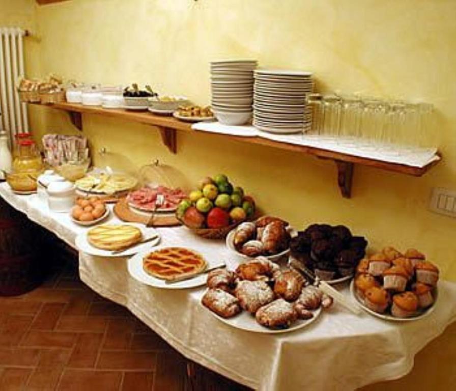 a table with many plates of food on it at Villa Piccola Siena in Siena