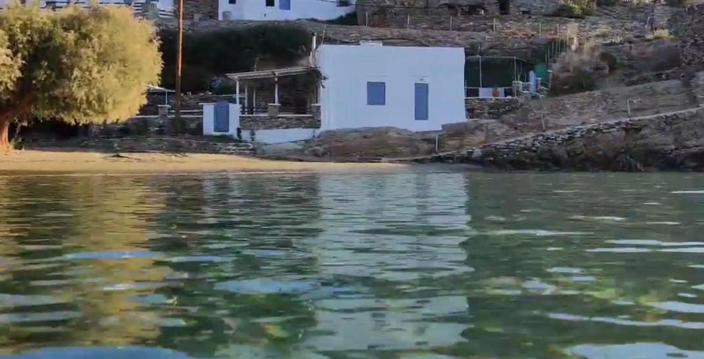 a view from the water of a beach with a white house at Kyma Residence in Faros