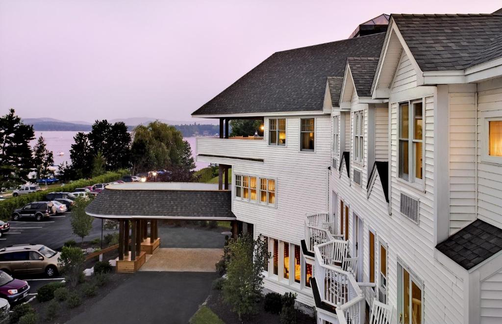 an aerial view of a white house with a parking lot at Wolfeboro Inn in Wolfeboro