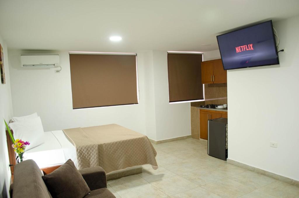 TV a/nebo společenská místnost v ubytování Hotel El Faro Buga