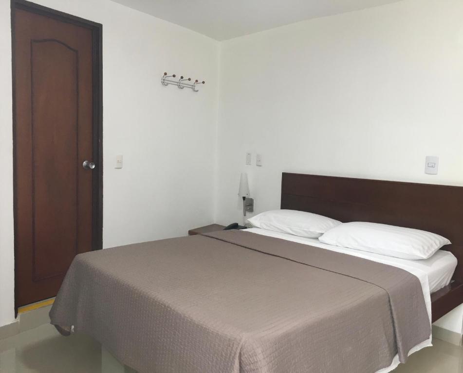 Postel nebo postele na pokoji v ubytování Hotel El Faro Buga
