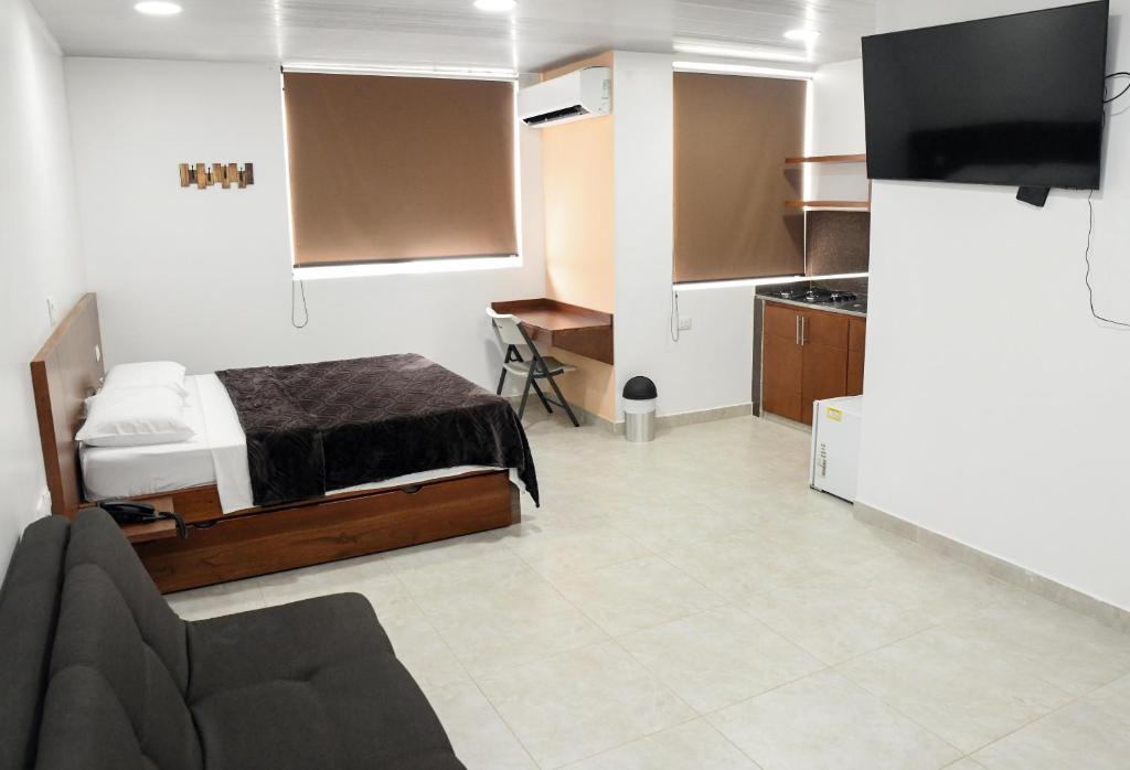 TV a/nebo společenská místnost v ubytování Hotel El Faro Buga