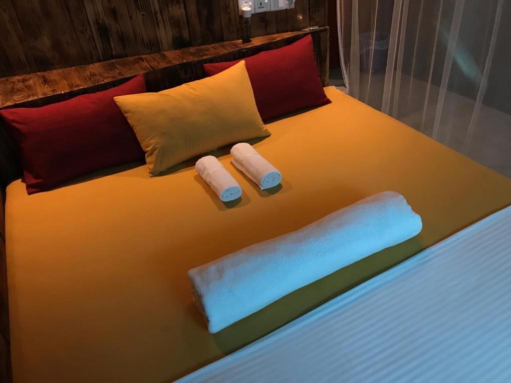 a bed with two towels and pillows on it at La pinchi " Pinchi's Bed " in Gampola