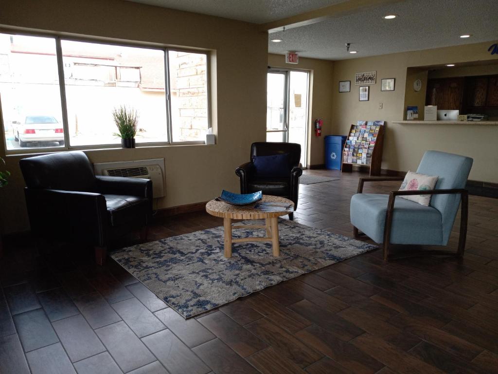 a waiting room with chairs and a coffee table at Super 8 Belen in Belen