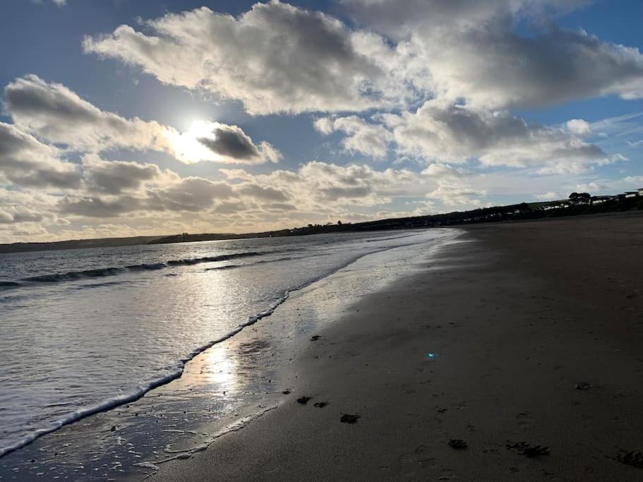 a beach with the sun reflecting on the water at Idyllic holiday near Abersoch in Mynytho