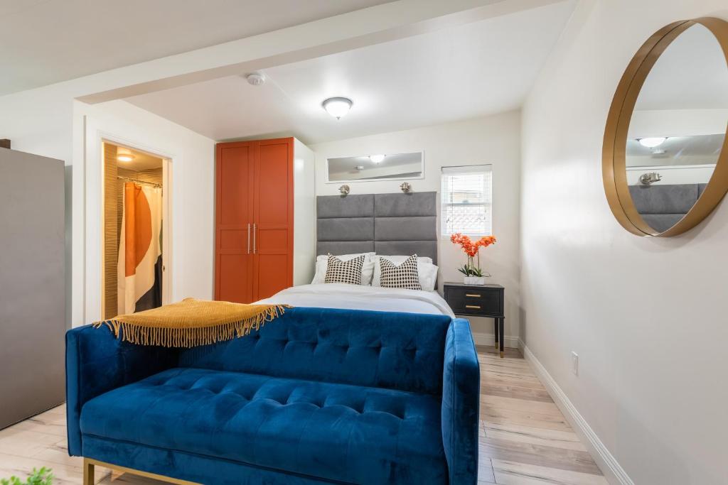 a bedroom with a blue couch in front of a bed at Private Guesthouse - Los Angeles in Los Angeles