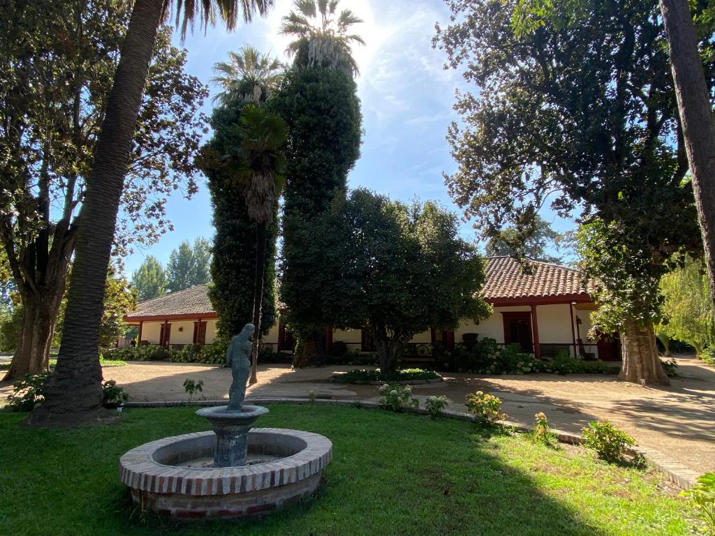 a statue in a park in front of a house at CASONA SAN PEDRO Hotel Boutique in San Javier